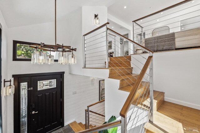 entryway featuring stairway, baseboards, recessed lighting, and wood finished floors