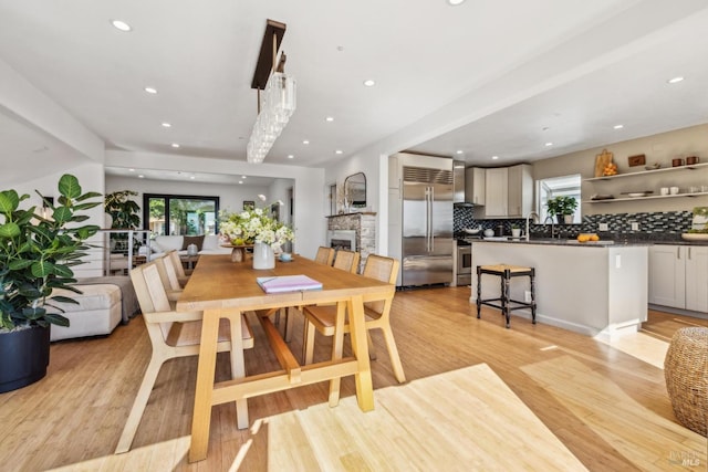 dining area with recessed lighting and light wood finished floors