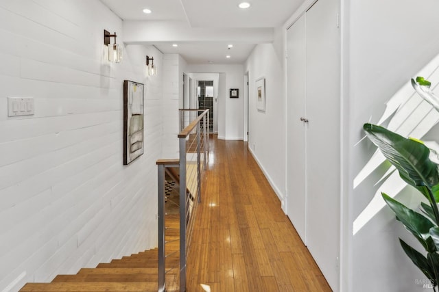 hall featuring recessed lighting, an upstairs landing, and hardwood / wood-style floors
