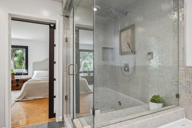 ensuite bathroom with connected bathroom and a shower stall