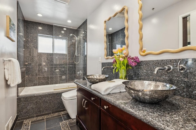 bathroom with tile patterned flooring, vanity, toilet, recessed lighting, and tiled shower / bath