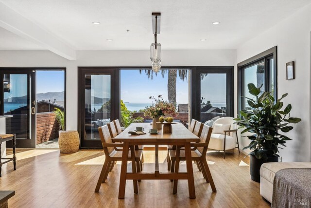 dining area featuring recessed lighting, wood finished floors, and beam ceiling