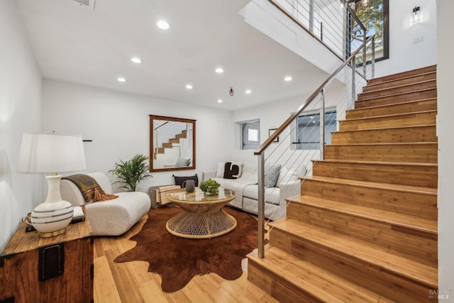 interior space featuring stairs, recessed lighting, and wood finished floors