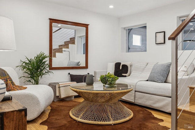 living room featuring recessed lighting, wood finished floors, and stairway