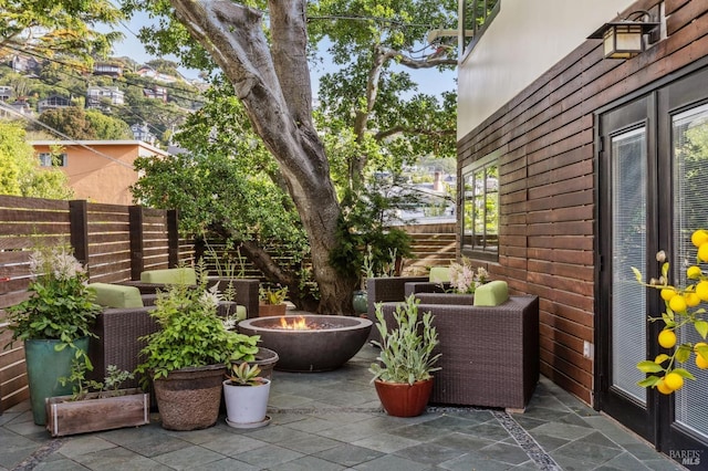view of patio / terrace featuring fence and a fire pit