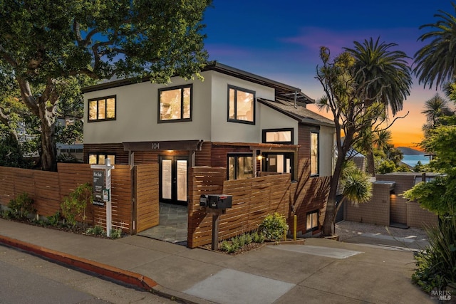 view of front facade with a fenced front yard and stucco siding