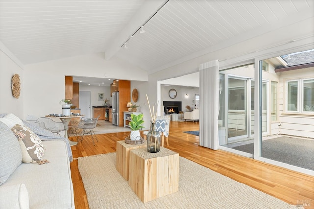 13 Leeward Rd, Belvedere, CA 94920 - living room with light wood finished floors, lofted ceiling with beams, rail lighting, and a warm lit fireplace