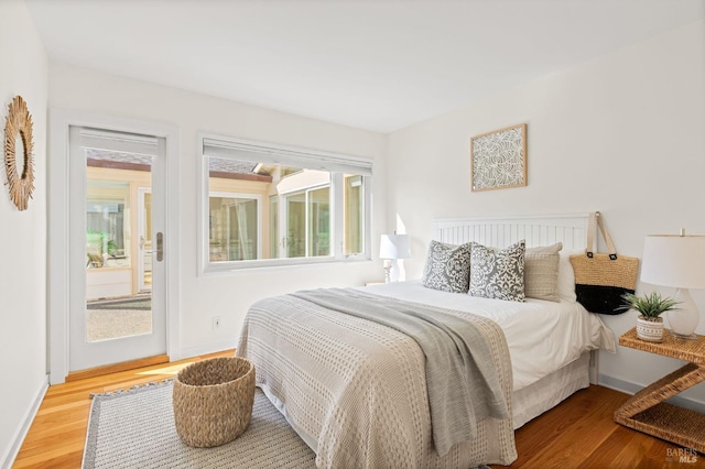 13 Leeward Rd, Belvedere, CA 94920 - bedroom with access to outside, wood finished floors, and baseboards
