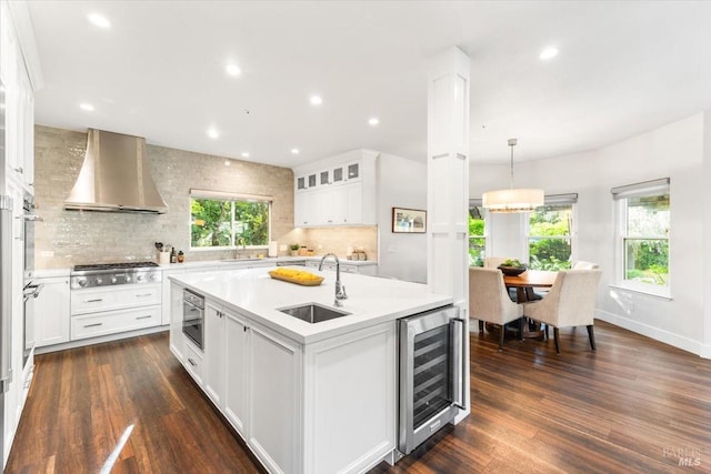 433 Tee Ct, Healdsburg, CA 95448 - kitchen featuring wall chimney range hood, light countertops, wine cooler, stainless steel gas stovetop, and a sink
