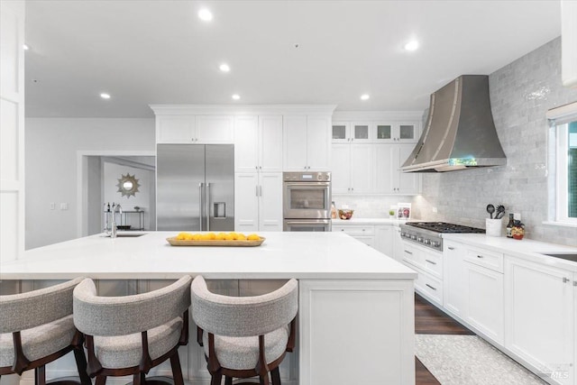 433 Tee Ct, Healdsburg, CA 95448 - kitchen with white cabinets, wall chimney exhaust hood, a sink, stainless steel appliances, and backsplash
