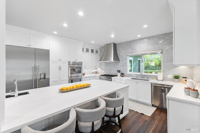 433 Tee Ct, Healdsburg, CA 95448 - kitchen featuring wall chimney range hood, a breakfast bar, a sink, and appliances with stainless steel finishes