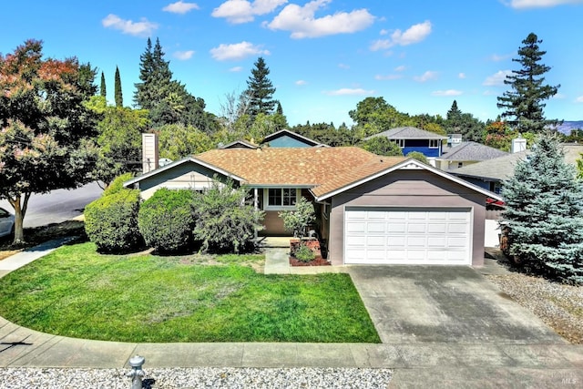view of front of property featuring a garage, driveway, and a front lawn