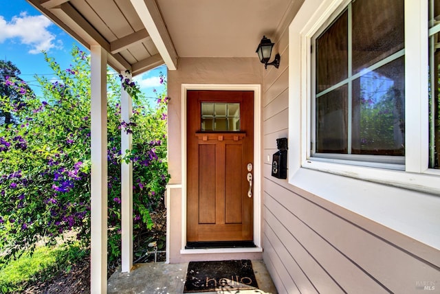 doorway to property with stucco siding
