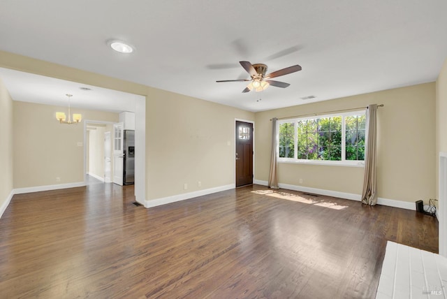 unfurnished living room featuring ceiling fan with notable chandelier, baseboards, dark wood finished floors, and visible vents