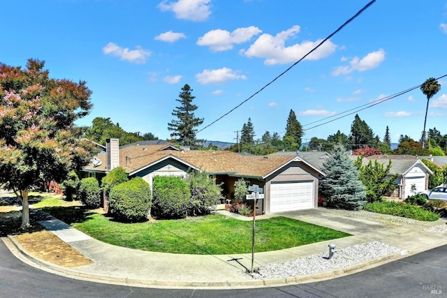 ranch-style house featuring concrete driveway and a front yard
