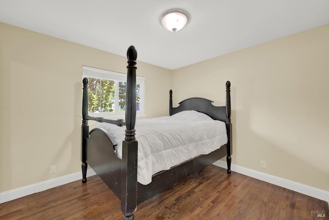 bedroom featuring baseboards and wood finished floors