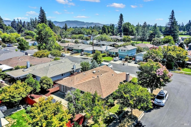 drone / aerial view featuring a residential view and a mountain view