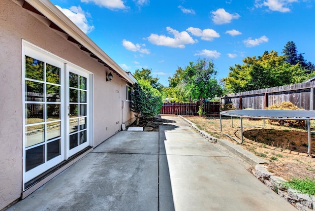 view of patio / terrace with a trampoline and a fenced backyard