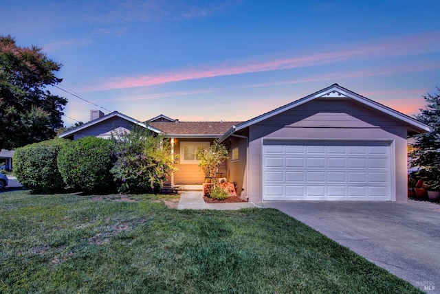 ranch-style house featuring concrete driveway, a front yard, stucco siding, and a garage