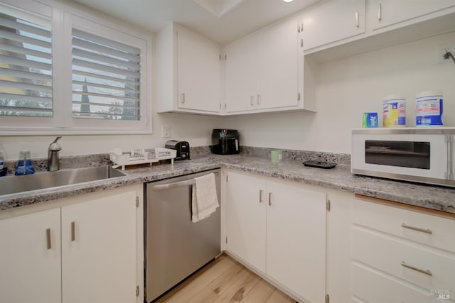 368 Lily St, Fairfield, CA 94533 - kitchen featuring stainless steel dishwasher, white microwave, light wood-style floors, white cabinetry, and light countertops
