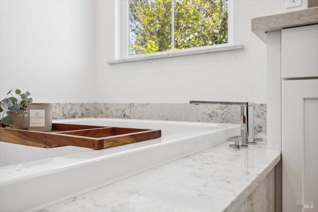 bathroom with a tub to relax in