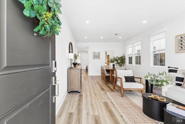 foyer with visible vents, light wood-style flooring, recessed lighting, and baseboards