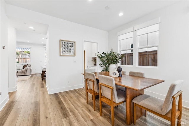 dining room featuring recessed lighting, light wood-style floors, and baseboards