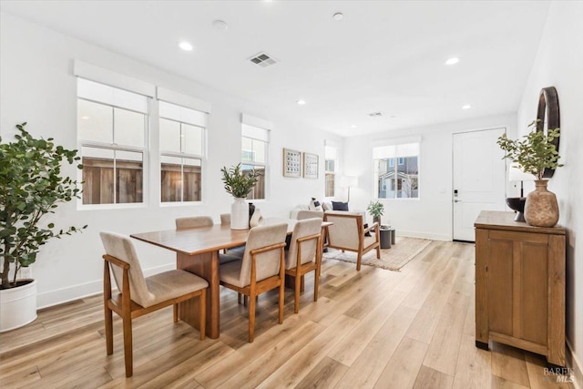 dining room featuring light wood finished floors, baseboards, visible vents, and recessed lighting