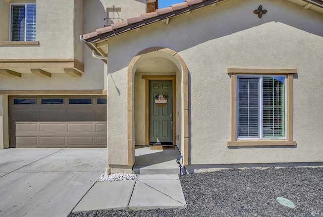 1090 Swarthmore Ct, Dixon, CA 95620 - doorway to property featuring concrete driveway, stucco siding, and an attached garage