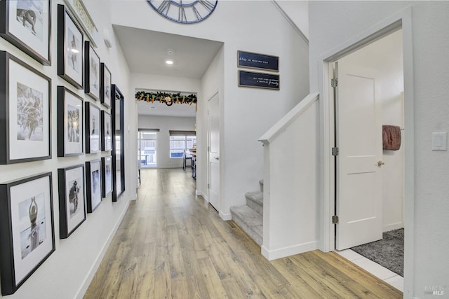 1090 Swarthmore Ct, Dixon, CA 95620 - corridor featuring light wood finished floors, stairway, baseboards, and recessed lighting