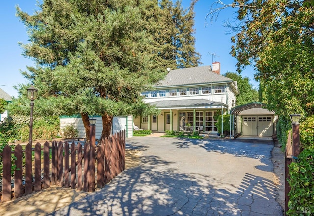 1436 Pine St, Napa, CA 94559 - view of front of home featuring a detached garage, a chimney, fence, a balcony, and an outbuilding