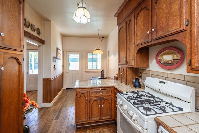 1436 Pine St, Napa, CA 94559 - kitchen featuring a peninsula, tile countertops, white gas range, and brown cabinets