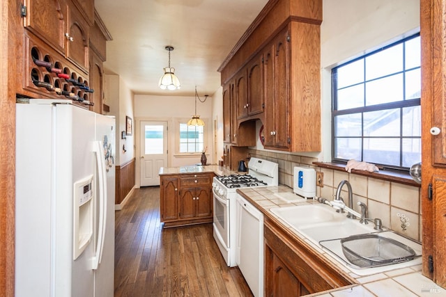 1436 Pine St, Napa, CA 94559 - kitchen with hanging light fixtures, white appliances, dark wood-style floors, brown cabinets, and tile countertops