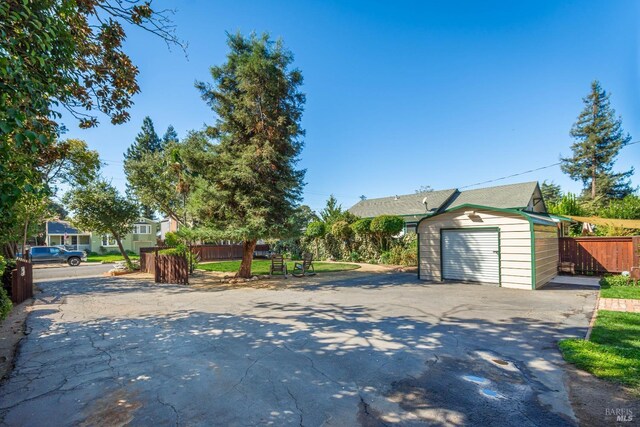 1436 Pine St, Napa, CA 94559 - view of front of house featuring concrete driveway, an outdoor structure, a storage shed, a garage, and fence