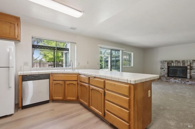220 Sandy Neck Way, Vallejo, CA 94591 - kitchen with dishwasher, freestanding refrigerator, a sink, a peninsula, and brown cabinets