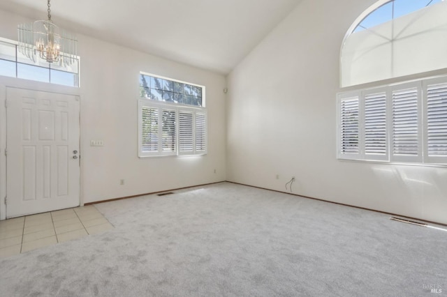 220 Sandy Neck Way, Vallejo, CA 94591 - entrance foyer with a chandelier, carpet floors, high vaulted ceiling, baseboards, and tile patterned flooring