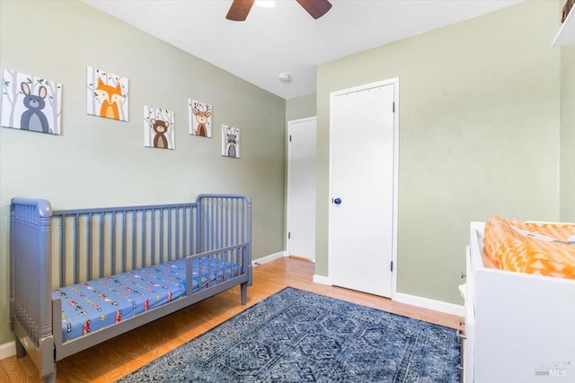 bedroom featuring baseboards, a ceiling fan, and wood finished floors