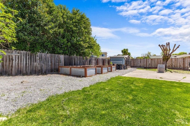 view of yard with a fenced backyard and a vegetable garden