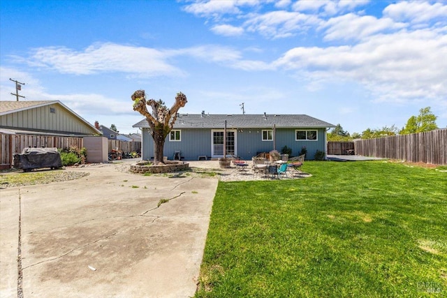 back of house featuring a patio area, a fenced backyard, and a yard