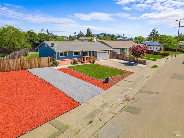 single story home with concrete driveway, a front yard, fence, and a garage