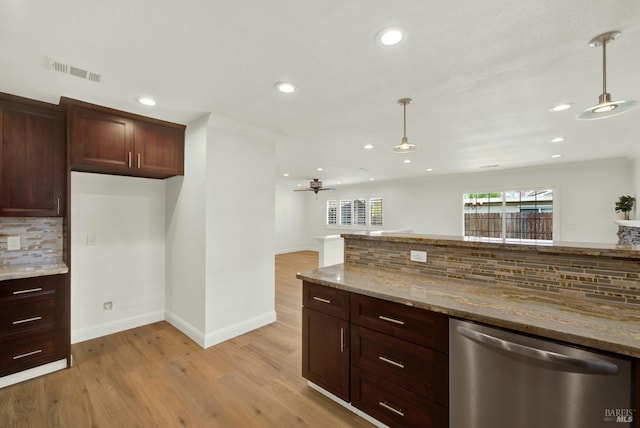 kitchen featuring visible vents, stainless steel dishwasher, hanging light fixtures, and light stone countertops
