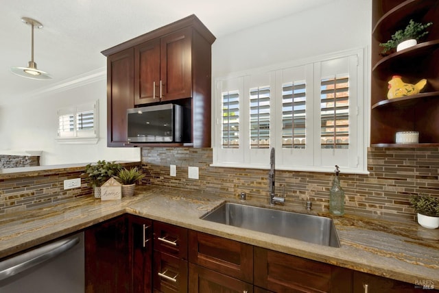 kitchen featuring a sink, decorative backsplash, appliances with stainless steel finishes, and light stone countertops