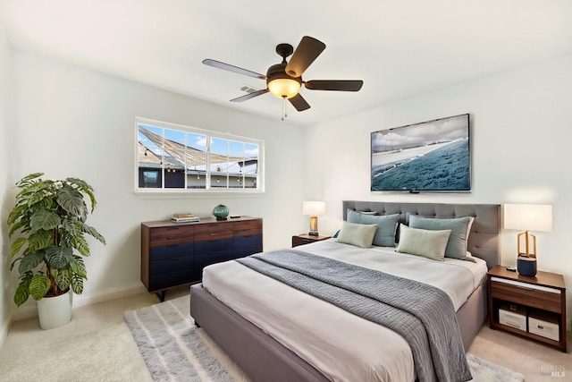 bedroom featuring visible vents, ceiling fan, light carpet, and baseboards