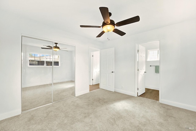 unfurnished bedroom with carpet, multiple windows, and baseboards