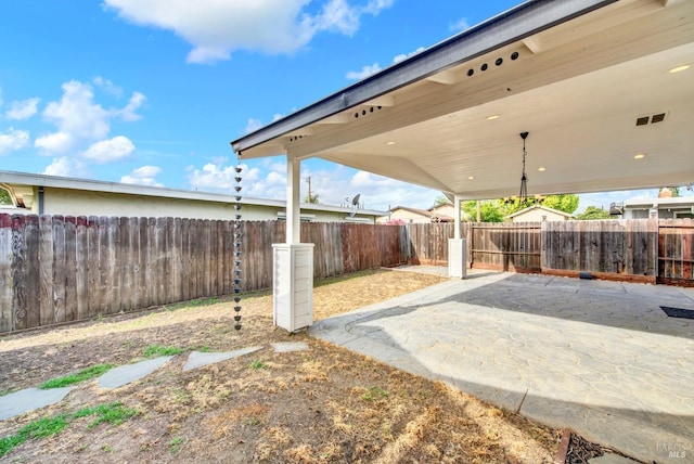view of yard with a patio, visible vents, and a fenced backyard