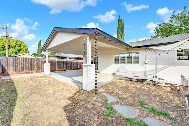 back of property featuring crawl space, a patio, and fence