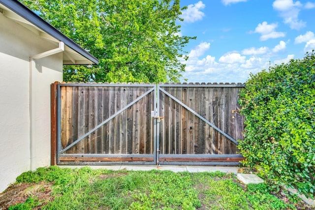 view of gate with fence