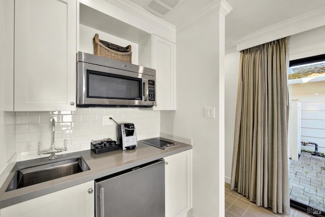 1600 Atlas Peak Rd Unit 286, Napa, CA 94558 - kitchen with stainless steel microwave, crown molding, white cabinets, dishwashing machine, and a sink