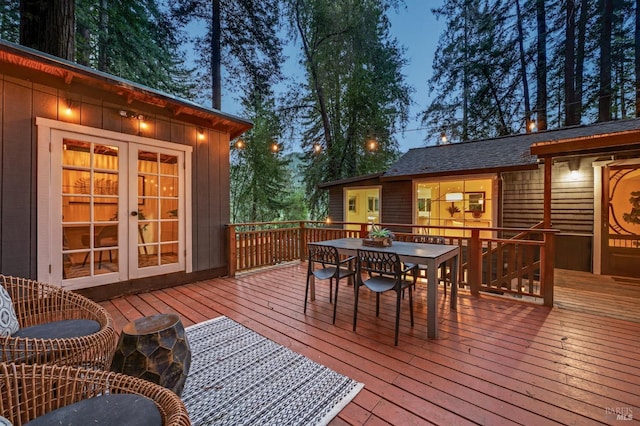 deck featuring outdoor dining area and french doors