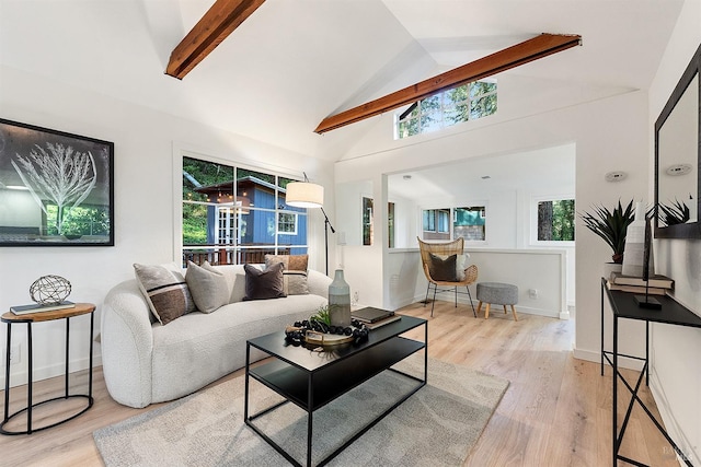 living room with baseboards, vaulted ceiling with beams, plenty of natural light, and wood finished floors